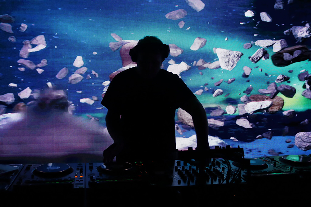 DJ silhouette performing in front of an LED video wall